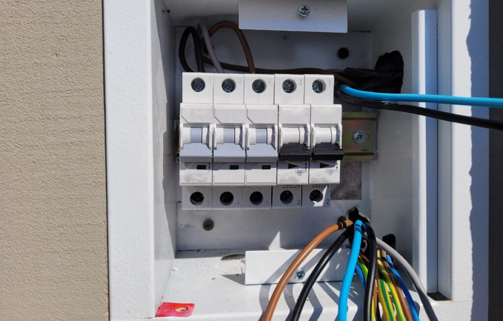 Un branchement électrique de 5 fils sur 4 fils dans un tableau avec du disjoncteur