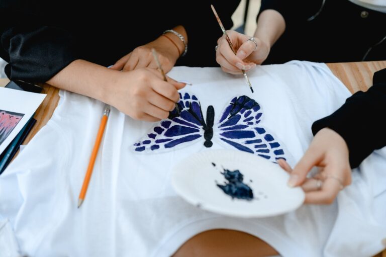 Des personnes décorant un t-shirt avec de la peinture